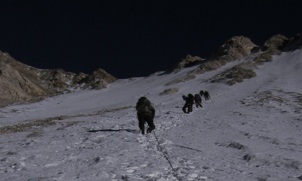 Steep snow chute leads to a technical rocky ridge