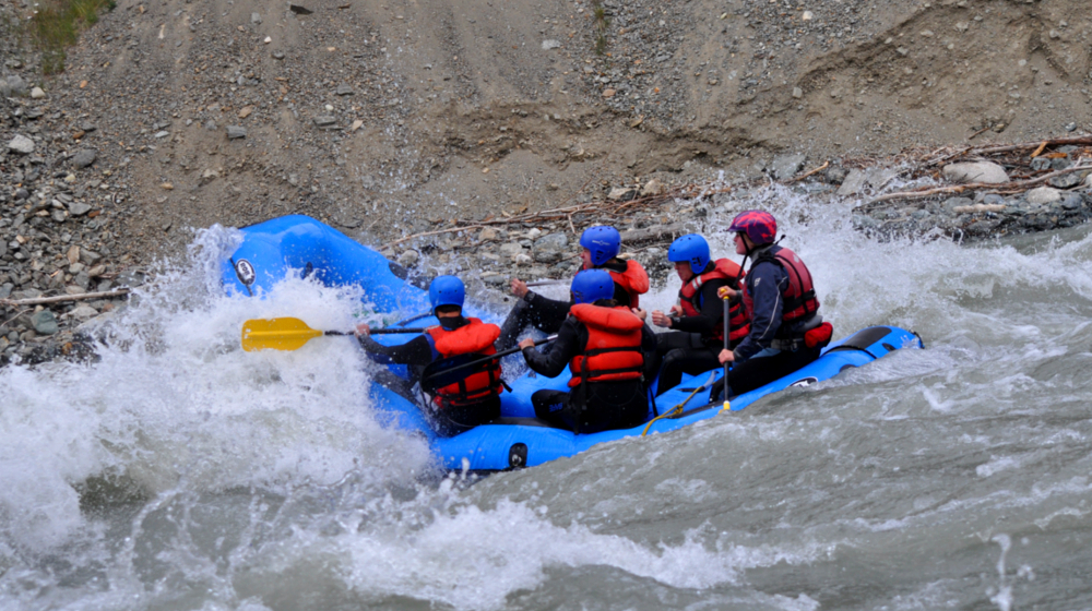 Students navigate a tight canyon rapid in one of the paddle rafts